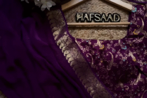 A pure chinnon purple jacquard and embroidery saree is a stunning choice for traditional and festive occasions