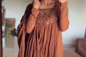 Elegant Hand-Embroidered Rust Brown Anarkali Dress with Flowy Pleats and Intricate Floral Details