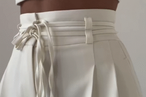 High-Waist Stone Beige Tailored Palazzo Pants with Waist-Cinch Belt Detailing – Elegant Pleated Wide-Leg Trousers for Modern Minimalist Fashion