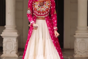 Traditional Kutchi Mirror Work Embroidered Pink Long Jacket with White Flared Lehenga – Navratri & Festive Special Ethnic Wear Set for Women
